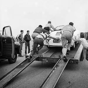 "James Dean, Pushing Porsche On Trailer" by Frank Worth