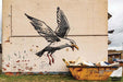 Seagull Raiding A Dumpster by Banksy's Graffiti