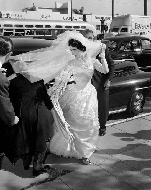 "Elizabeth Taylor Fixes Train of First Wedding Dress" by Frank Worth